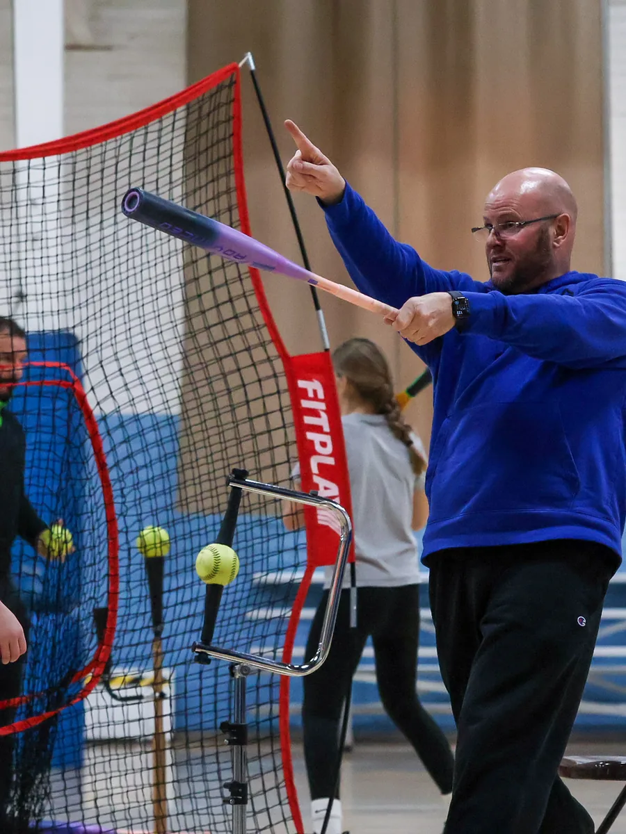 Kevin Staggs coaching an athlete through a swing