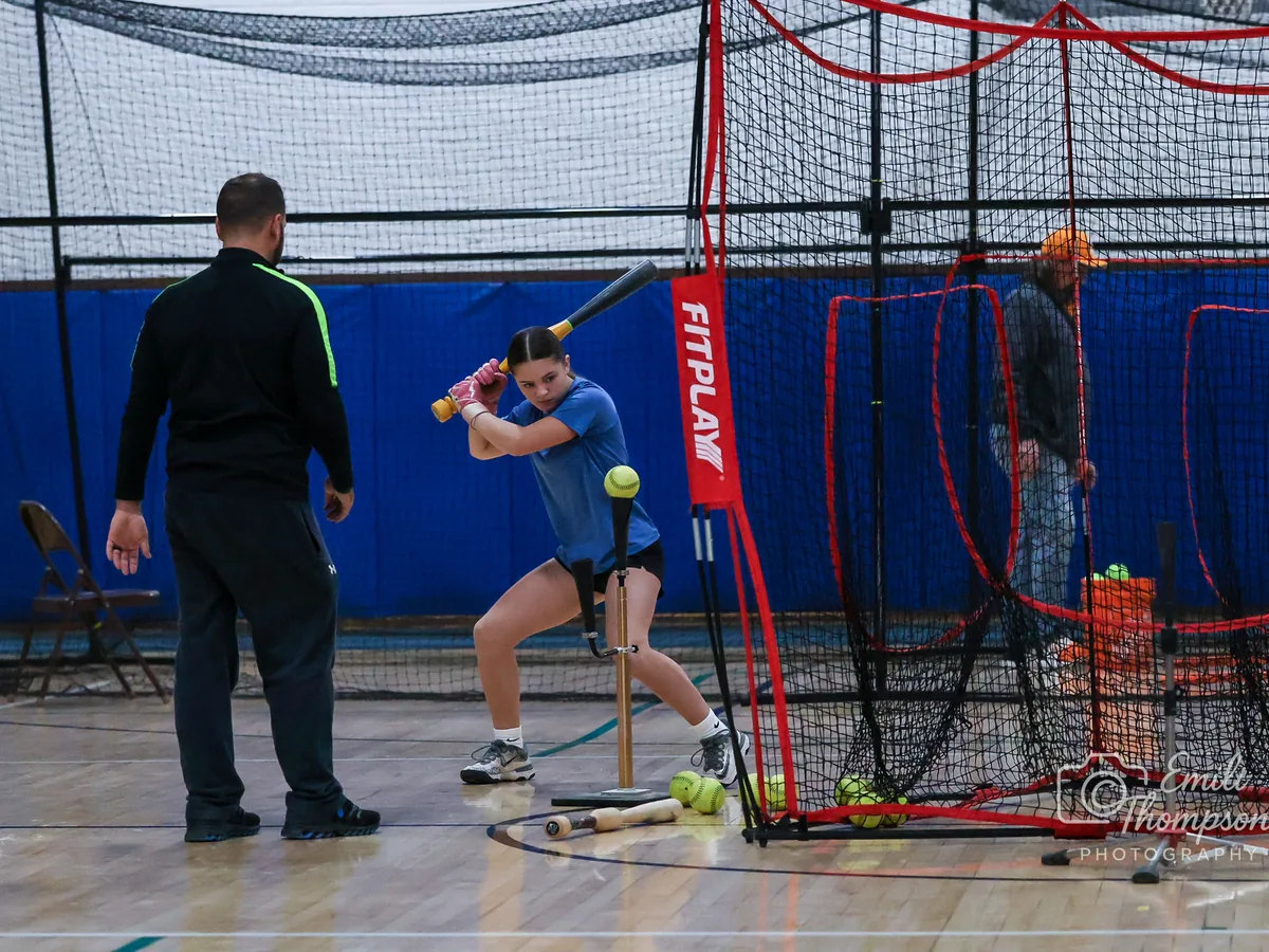 A coach working with a hitter during a session